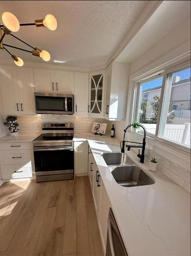 232 Deerpoint Se, Calgary, AB - Indoor Photo Showing Kitchen With Double Sink