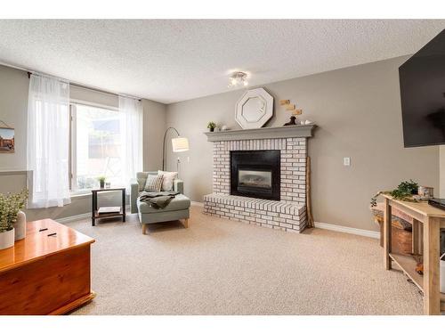 309 Sunvale Drive Se, Calgary, AB - Indoor Photo Showing Living Room With Fireplace