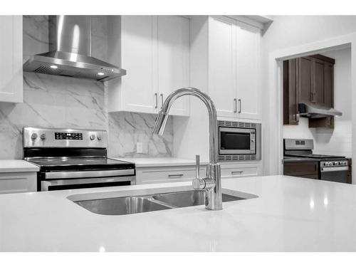 113 Creekside Way Sw, Calgary, AB - Indoor Photo Showing Kitchen With Double Sink With Upgraded Kitchen