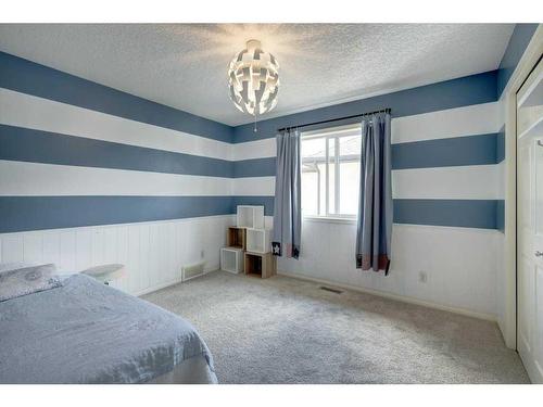 19 Crystal Shores Road, Okotoks, AB - Indoor Photo Showing Bedroom