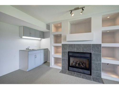 19 Crystal Shores Road, Okotoks, AB - Indoor Photo Showing Living Room With Fireplace