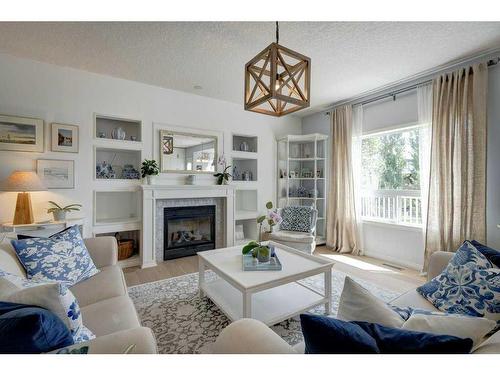 19 Crystal Shores Road, Okotoks, AB - Indoor Photo Showing Living Room With Fireplace