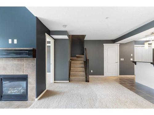 312-141 Mountain Street, Cochrane, AB - Indoor With Fireplace