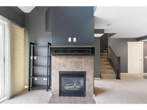 312-141 Mountain Street, Cochrane, AB - Indoor With Fireplace