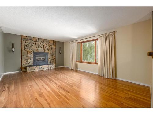 1012 Cannock Road Sw, Calgary, AB - Indoor Photo Showing Living Room With Fireplace
