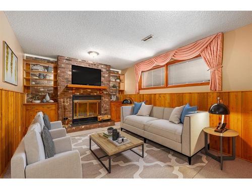 1012 Cannock Road Sw, Calgary, AB - Indoor Photo Showing Living Room With Fireplace