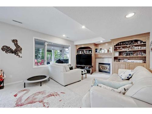 468 Mckenzie Lake Bay Se, Calgary, AB - Indoor Photo Showing Living Room With Fireplace