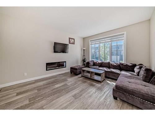 163 Belvedere Green Se, Calgary, AB - Indoor Photo Showing Living Room With Fireplace