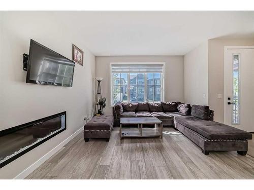 163 Belvedere Green Se, Calgary, AB - Indoor Photo Showing Living Room With Fireplace