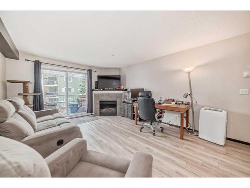 2304-10 Prestwick Bay Se, Calgary, AB - Indoor Photo Showing Living Room With Fireplace