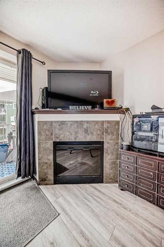 2304-10 Prestwick Bay Se, Calgary, AB - Indoor With Fireplace