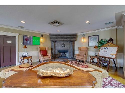 404-1718 14 Avenue Nw, Calgary, AB - Indoor Photo Showing Living Room With Fireplace