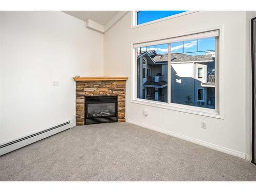 428-345 Rocky Vista Park Nw, Calgary, AB - Indoor Photo Showing Living Room With Fireplace