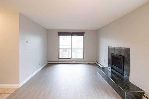 106-2611 15A Street Sw, Calgary, AB - Indoor With Fireplace