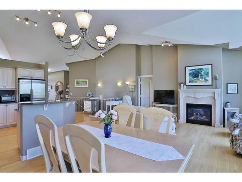 421 Rocky Vista Gardens Nw, Calgary, AB - Indoor Photo Showing Dining Room With Fireplace