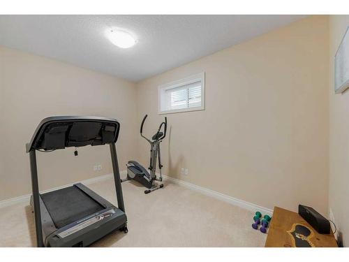 22 Discovery Woods Villas Sw, Calgary, AB - Indoor Photo Showing Gym Room