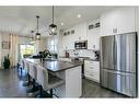 36 Drake Landing Gardens, Okotoks, AB  - Indoor Photo Showing Kitchen With Double Sink With Upgraded Kitchen 