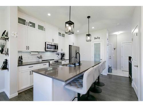 36 Drake Landing Gardens, Okotoks, AB - Indoor Photo Showing Kitchen With Double Sink With Upgraded Kitchen