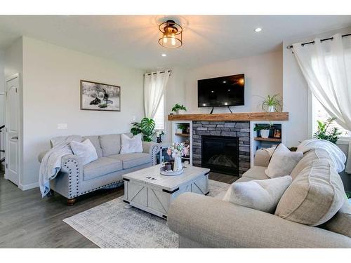 36 Drake Landing Gardens, Okotoks, AB - Indoor Photo Showing Living Room With Fireplace