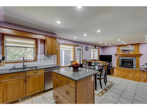 281 Westchester Green, Chestermere, AB - Indoor Photo Showing Kitchen With Fireplace With Double Sink