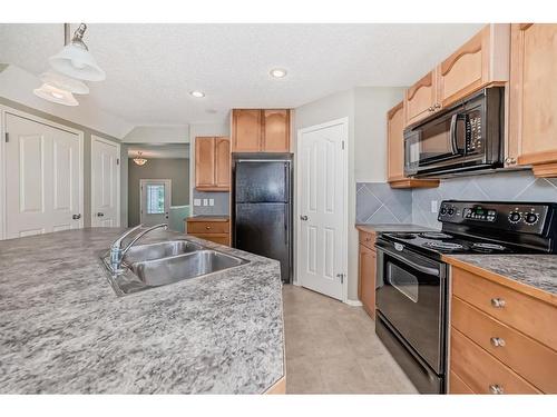 329 Eversyde Circle Sw, Calgary, AB - Indoor Photo Showing Kitchen With Double Sink