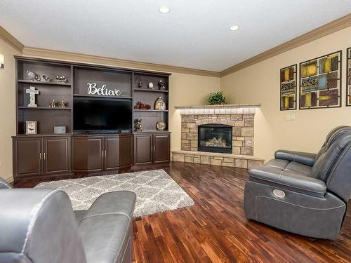 1628 25 Avenue, Didsbury, AB - Indoor Photo Showing Living Room With Fireplace