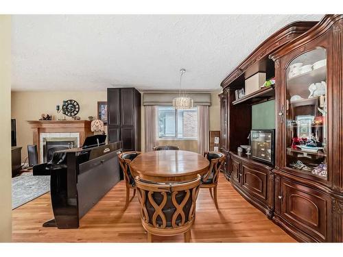 8016 7 Street Sw, Calgary, AB - Indoor Photo Showing Dining Room With Fireplace