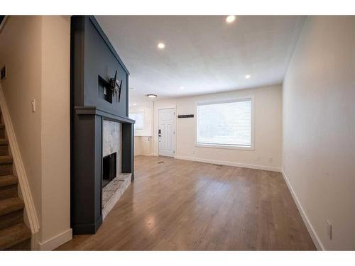 63-740 Bracewood Drive Sw, Calgary, AB - Indoor Photo Showing Other Room With Fireplace