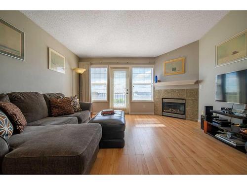 303-4718 Stanley Road Sw, Calgary, AB - Indoor Photo Showing Living Room With Fireplace