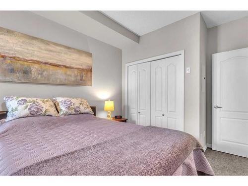 208-1 Crystal Green, Okotoks, AB - Indoor Photo Showing Bedroom