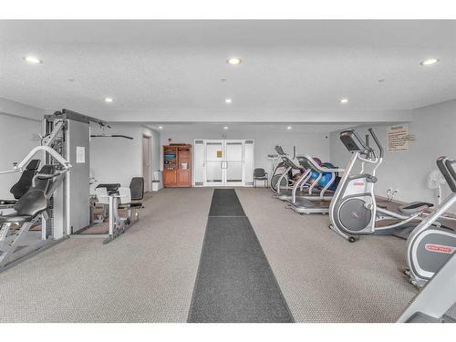 208-1 Crystal Green, Okotoks, AB - Indoor Photo Showing Gym Room