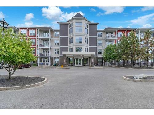 208-1 Crystal Green, Okotoks, AB - Outdoor With Balcony With Facade