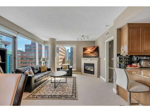 1004-910 5 Avenue Sw, Calgary, AB - Indoor Photo Showing Living Room With Fireplace