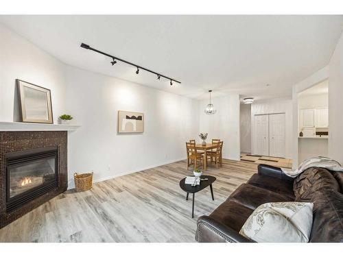 103-15212 Bannister Road Se, Calgary, AB - Indoor Photo Showing Living Room With Fireplace