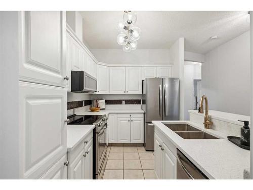103-15212 Bannister Road Se, Calgary, AB - Indoor Photo Showing Kitchen With Double Sink With Upgraded Kitchen