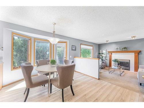 307 Schubert Place Nw, Calgary, AB - Indoor Photo Showing Dining Room With Fireplace