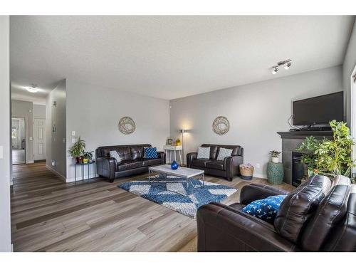 105 Everhollow Rise Sw, Calgary, AB - Indoor Photo Showing Living Room With Fireplace