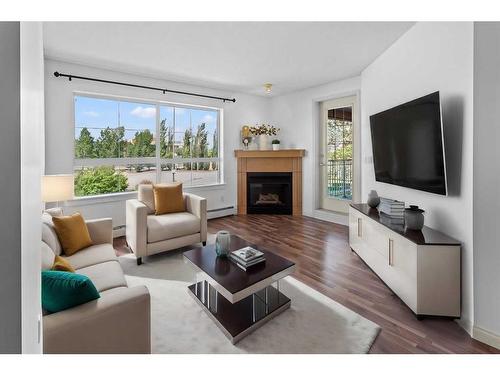 208-5115 Richard Road Sw, Calgary, AB - Indoor Photo Showing Living Room With Fireplace