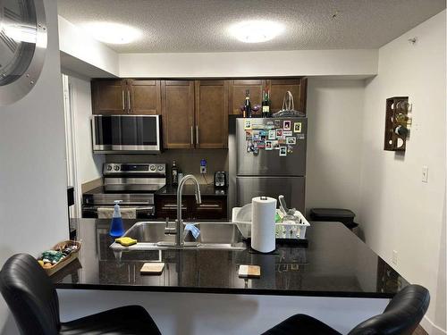 #410-7110 80 Avenue Ne, Calgary, AB - Indoor Photo Showing Kitchen With Double Sink