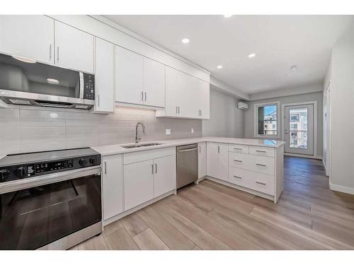 308-125 Wolf Willow Crescent Se, Calgary, AB - Indoor Photo Showing Kitchen With Double Sink