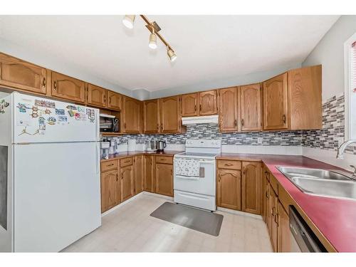 12 Hidden Valley Link Nw, Calgary, AB - Indoor Photo Showing Kitchen With Double Sink