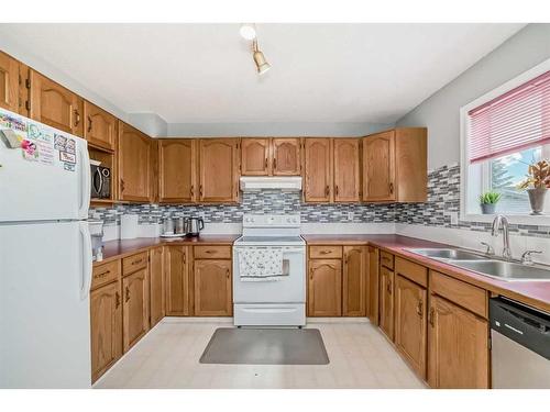 12 Hidden Valley Link Nw, Calgary, AB - Indoor Photo Showing Kitchen With Double Sink