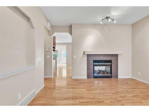 196 Panamount Circle Nw, Calgary, AB - Indoor Photo Showing Living Room With Fireplace