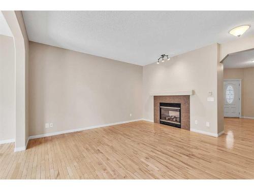 196 Panamount Circle Nw, Calgary, AB - Indoor Photo Showing Living Room With Fireplace