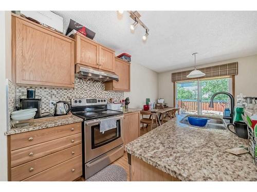 122 Royal Birch Gardens Nw, Calgary, AB - Indoor Photo Showing Kitchen With Double Sink