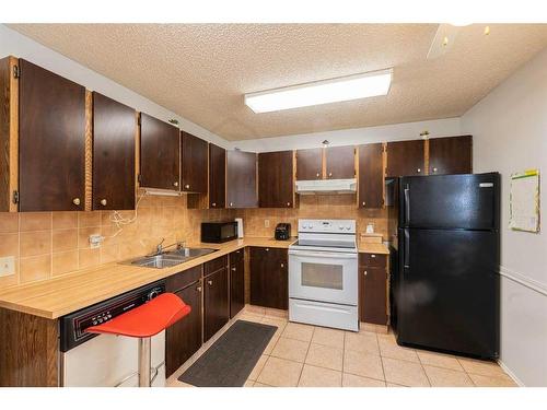 17 Bernard Drive Nw, Calgary, AB - Indoor Photo Showing Kitchen With Double Sink