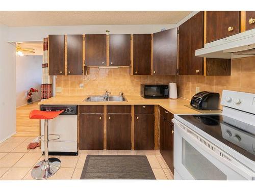 17 Bernard Drive Nw, Calgary, AB - Indoor Photo Showing Kitchen With Double Sink