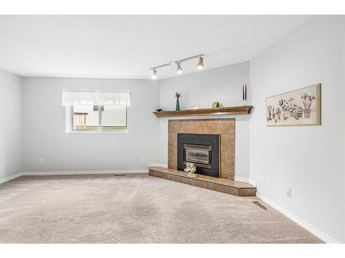 37 Shawinigan Drive Sw, Calgary, AB - Indoor Photo Showing Living Room With Fireplace