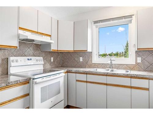 37 Shawinigan Drive Sw, Calgary, AB - Indoor Photo Showing Kitchen With Double Sink
