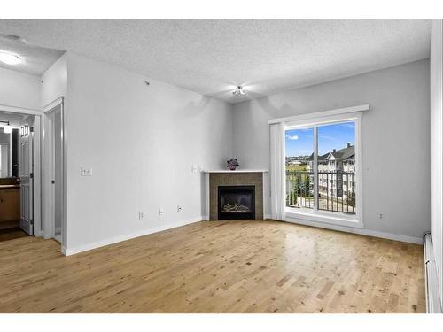 1411-5 Country Village Park Ne, Calgary, AB - Indoor Photo Showing Living Room With Fireplace
